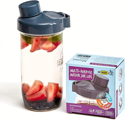 a glass jar filled with sliced strawberries next to a box of fruit