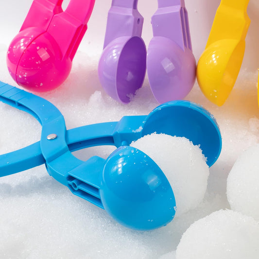 a pair of scissors sitting on top of a pile of snow