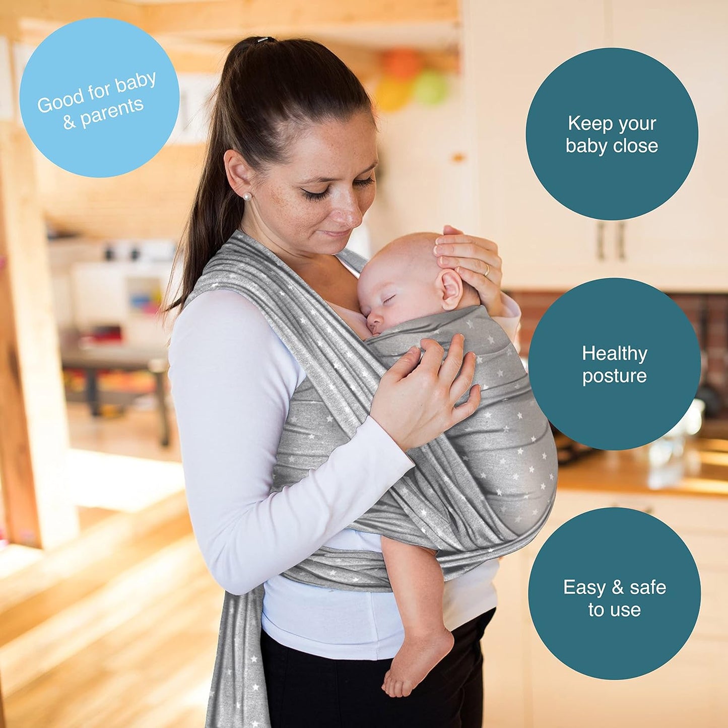 a woman holding a baby in a baby sling