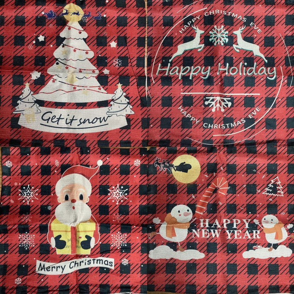 a red and black plaid fabric with christmas stickers on it