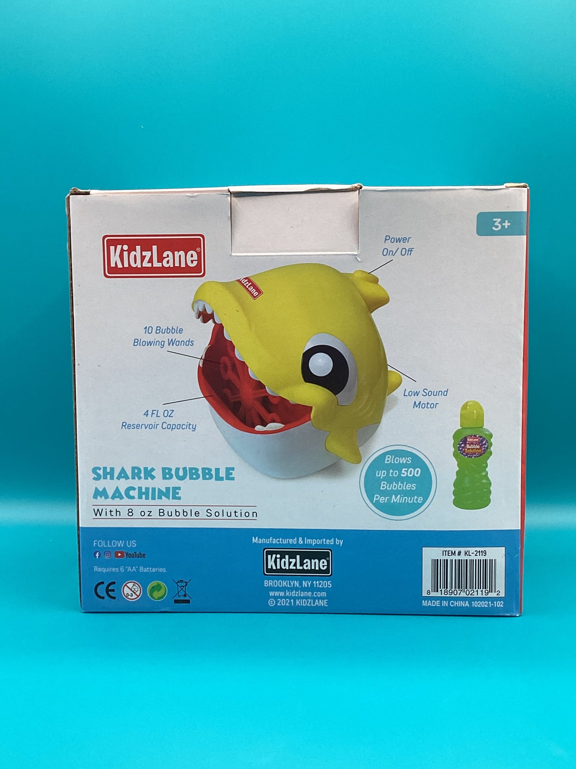 a box with a toy shark inside of it