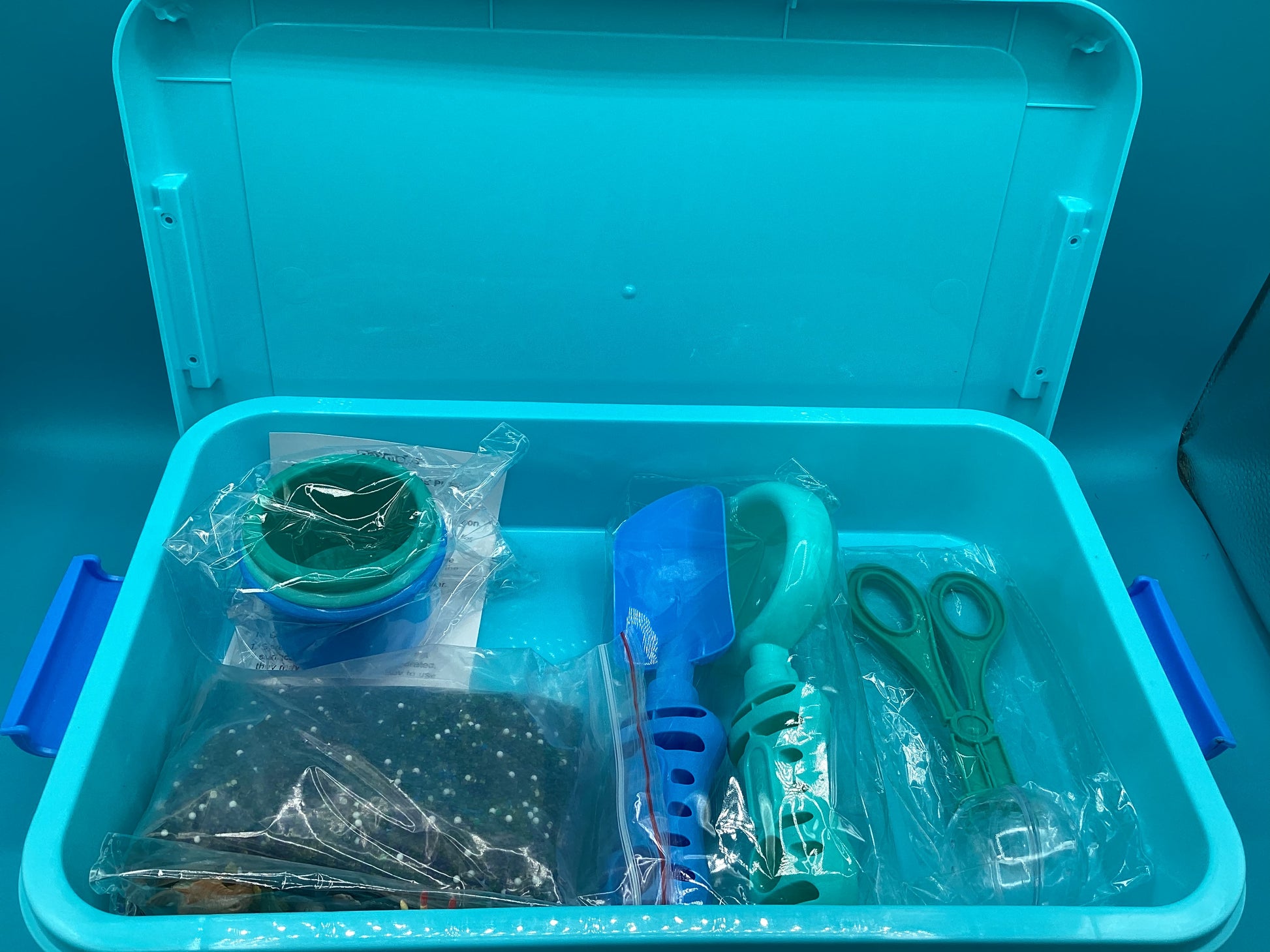 a blue suitcase filled with lots of different items