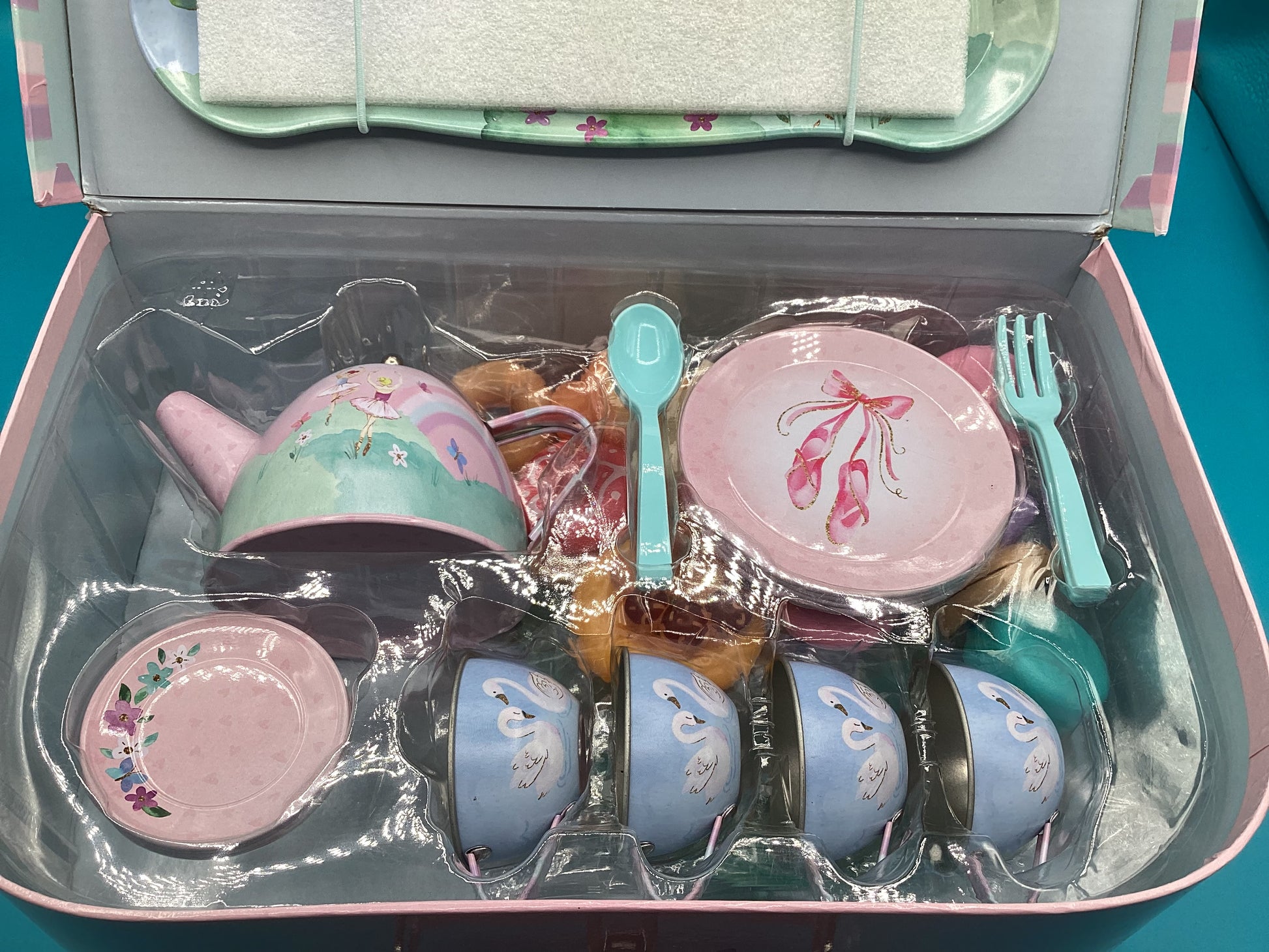 a pink box filled with pink and blue dishes