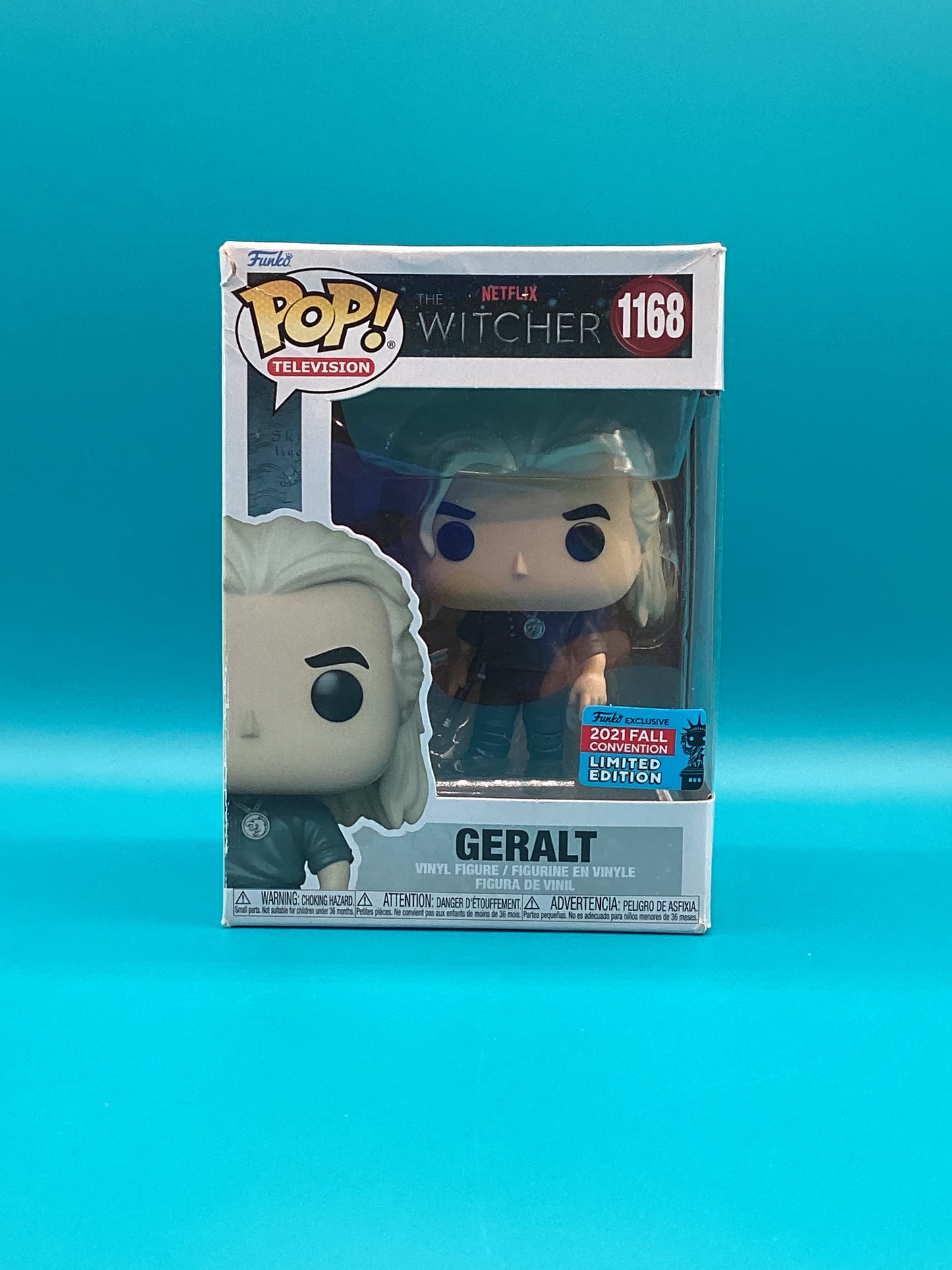 a pop vinyl figure in a box on a blue background